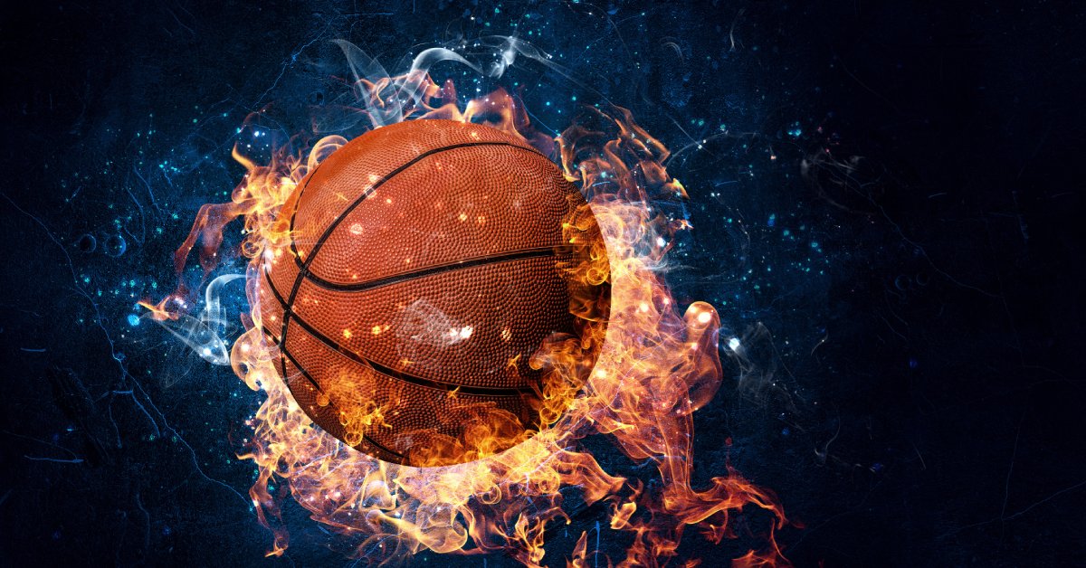 A traditional basketball has yellow and blue flames surrounding it. A black background makes the basketball pop.